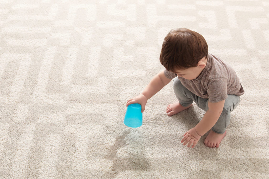 child spilling on carpet - Shiny Cleaners - Carpet Cleaning Services
